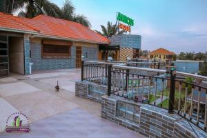 a restaurant with a fence in front of a building at Amicus Hotel Kampala in Kireka