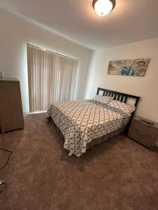 a bedroom with a bed with a comforter and a window at New Building Downtown Atlanta Condo in Atlanta