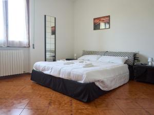 a large bed in a white room with a large bedvisor at A casa di Titti Arezzo in Arezzo