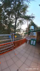 an orange fence sitting on top of a patio at TIKOO'S PEAK & PINE in Dalhousie