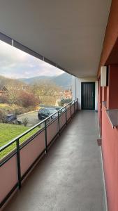 a hallway with a balcony with a view of a car at FeWo Talblick 22 in Bad Lauterberg