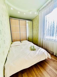 ein Schlafzimmer mit einem Bett mit zwei Handtüchern darauf in der Unterkunft Kholodnaya gora in Kharkov