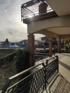 a porch with a metal railing and a bridge at Casa dei Demi in Pieve di Soligo