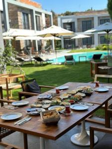 Malta Hotel Bodrum في بودروم: طاولة خشبية عليها صحون طعام