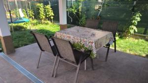 a table with four chairs and a table with a table cloth at Tea House Samokov in Samokov