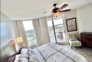 a bedroom with a bed and a ceiling fan at Coastal Oasis Retreat at The Palms of Destin! in Destin +29 photos