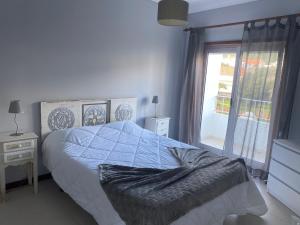 a bedroom with a bed and a large window at O Ninho 94 in Vila Praia de Âncora