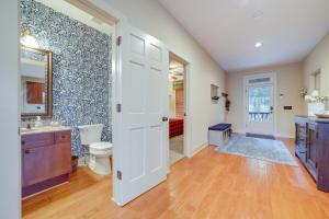 a bathroom with a toilet and a sink and a mirror at Lake Livin Lodge Cashiers Retreat with Mtn Views in Cashiers +32 photos