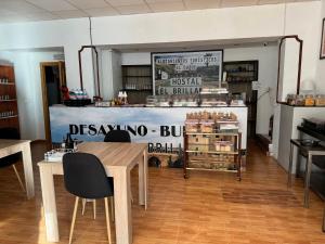 a store with a table and chairs in a room at Hostal El Brillante - Alojamientos El Duque in Córdoba