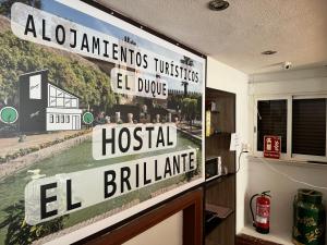 a sign hanging on a wall in a room at Hostal El Brillante - Alojamientos El Duque in Córdoba +45 photos