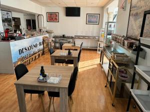 a restaurant with tables and chairs in a room at Hostal El Brillante - Alojamientos El Duque in Córdoba