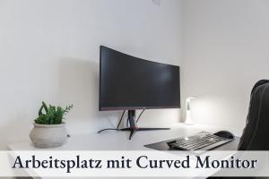 a computer monitor sitting on top of a desk at RelaxApartment 1 Massagesessel SmartTV Küche in Biberach an der Riß