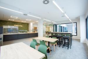 a dining area with tables and chairs in a cafeteria at Micampus Burjassot Parque Student Residence in Burjassot