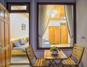 a room with a table and chairs and a window at LaMay Homestay in Da Lat +17 photos