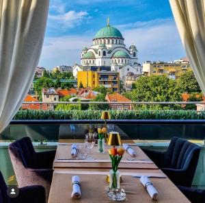 un ristorante con tavolo e vista sulla città di Apartment Sara a Belgrado