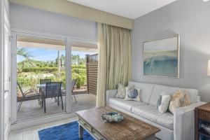 a living room with a couch and a table at Sandestin Resort Luau by Tufan in Destin