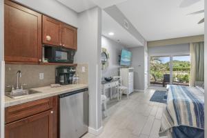 a kitchen with a sink and a counter top at Sandestin Resort Luau by Tufan in Destin