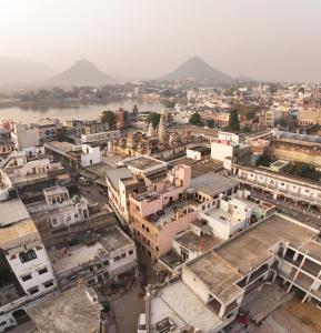 an aerial view of a city with a river and buildings at Kanhaia Haveli in Pushkar