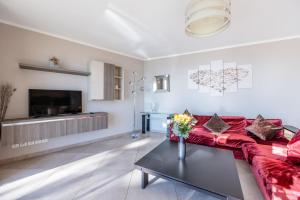 a living room with a red couch and a table at LE MIDI 8 by ESTATES CANNES in Cannes
