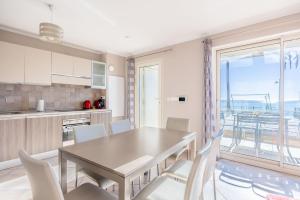 a kitchen and dining room with a table and chairs at LE MIDI 8 by ESTATES CANNES in Cannes