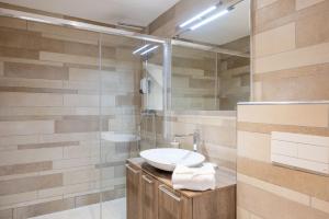 a bathroom with a sink and a shower at LE MIDI 8 by ESTATES CANNES in Cannes