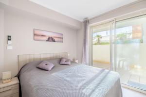 a bedroom with a bed with purple pillows on it at LE MIDI 8 by ESTATES CANNES in Cannes