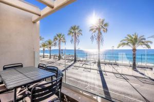 a balcony with a table and a view of the beach at LE MIDI 8 by ESTATES CANNES in Cannes