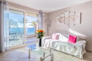 a bedroom with a bed and a view of the ocean at LE MIDI 8 by ESTATES CANNES in Cannes