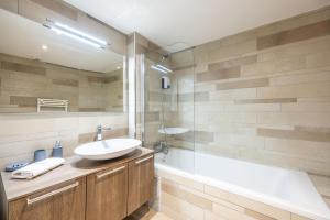 a bathroom with a sink and a tub at LE MIDI 8 by ESTATES CANNES in Cannes