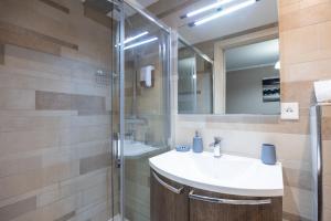 a bathroom with a sink and a shower at LE MIDI 8 by ESTATES CANNES in Cannes