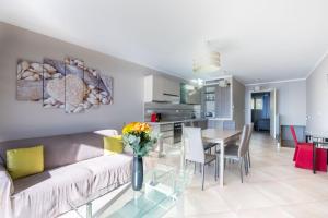 a living room and kitchen with a couch and a table at LE MIDI 8 by ESTATES CANNES in Cannes