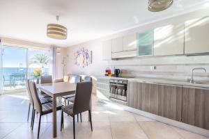 a kitchen and dining room with a table and chairs at LE MIDI 8 by ESTATES CANNES in Cannes