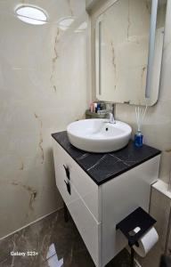 a bathroom with a sink and a mirror at Apartmaji STARS in Mavčiče