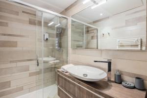 a bathroom with a sink and a shower at LE MIDI 8 by ESTATES CANNES in Cannes