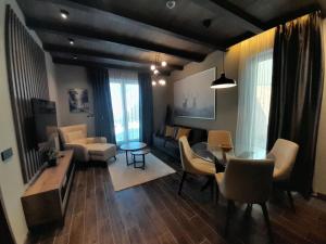 a living room with a couch and a table and chairs at Stefany in Kopaonik