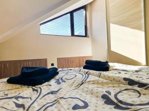 a bedroom with a bed with two pillows on it at IZ VIEW Apartment in Bansko