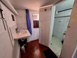 a bathroom with a sink and a shower at La Musica Hostel OuroPreto in Ouro Preto +131 photos