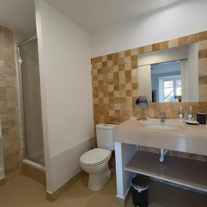 a bathroom with a toilet and a sink and a mirror at Tomarhousing - Style in Tomar