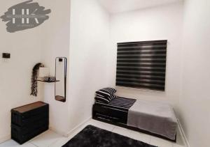 ein weißes Zimmer mit einem Bett und einem Fenster in der Unterkunft 3 Bedroom - HK Guesthouse Jerantut Pahang in Jerantut