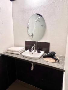 a bathroom sink with a mirror and a phone at Ko Phangan Haad Yao Beach Hotel in Haad Tian