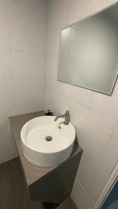 a bathroom with a white sink and a mirror at Ko Phangan Haad Yao Beach Hotel in Haad Tian