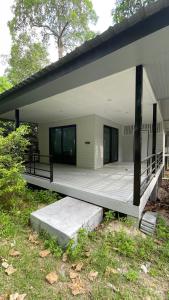 a large house with a porch and a deck at Ko Phangan Haad Yao Beach Hotel in Haad Tian