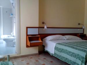 Voodi või voodid majutusasutuse Hotel Sette Note toas