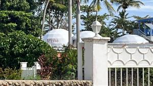 a white fence with two domes in the background at Arena Oceanview Hotel & La Terraza Restaurant in Las Galeras