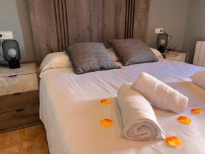 a bedroom with two beds with towels on them at CASA PUIG, Piscina Privada ,Aire Acondicionado Free in L'Escala +31 photos