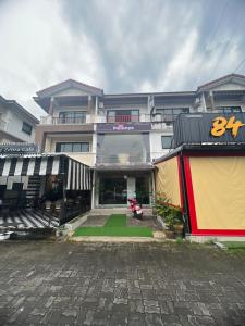 a building with a motorcycle parked in front of it at Petunya Phuket in Ban Huai Luk (1)