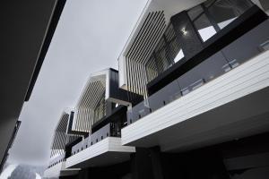 a view of a building with tall buildings at Black & White Villas by Fomich Hotels Group in Bukovel