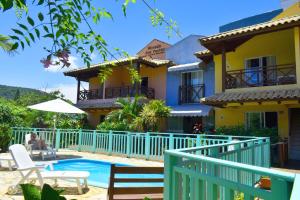 a house with a swimming pool in front of it at Morada Dos Ventos in Bombinhas