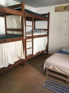 a room with three bunk beds in a room at Hostel Itaparica in Itaparica Town