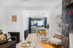 a living room with a couch and a table at Classy Abode in Hackney - Garden - Sleeps 6 in London